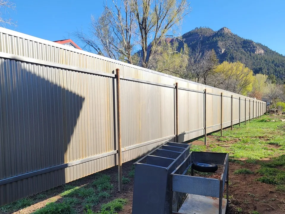 Corrugated metal fence with cedar accents