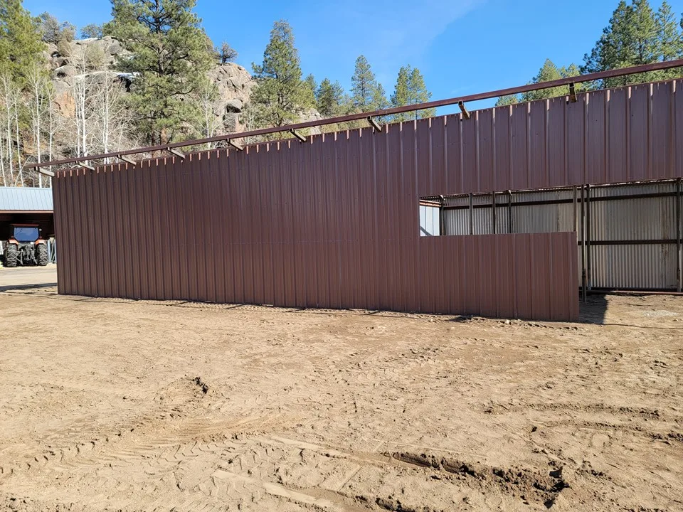 Custom loafing shed with corrugated metal roof and walls