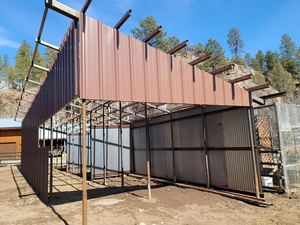 Loafing shed exterior with rusted corrugated metal siding